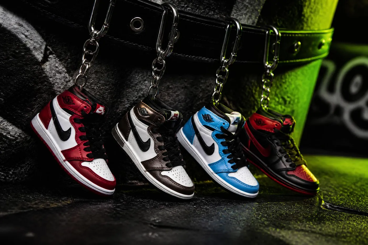 Bakost mini sneaker keychains on black concrete